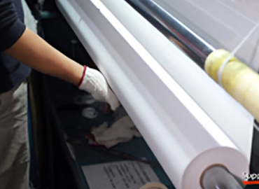 Workers are packing self-adhesive vinyl.