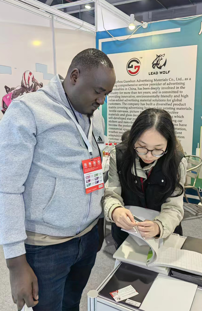 Taking photos with clients at the advertising materials trade show.