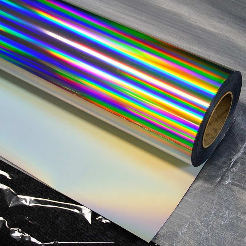 Holographic vinyl roll, transparent backing paper, strong adhesive, 120mic, 140gsm, printable.