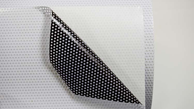 Real-life photos of one-way transparent vinyl film rolls.